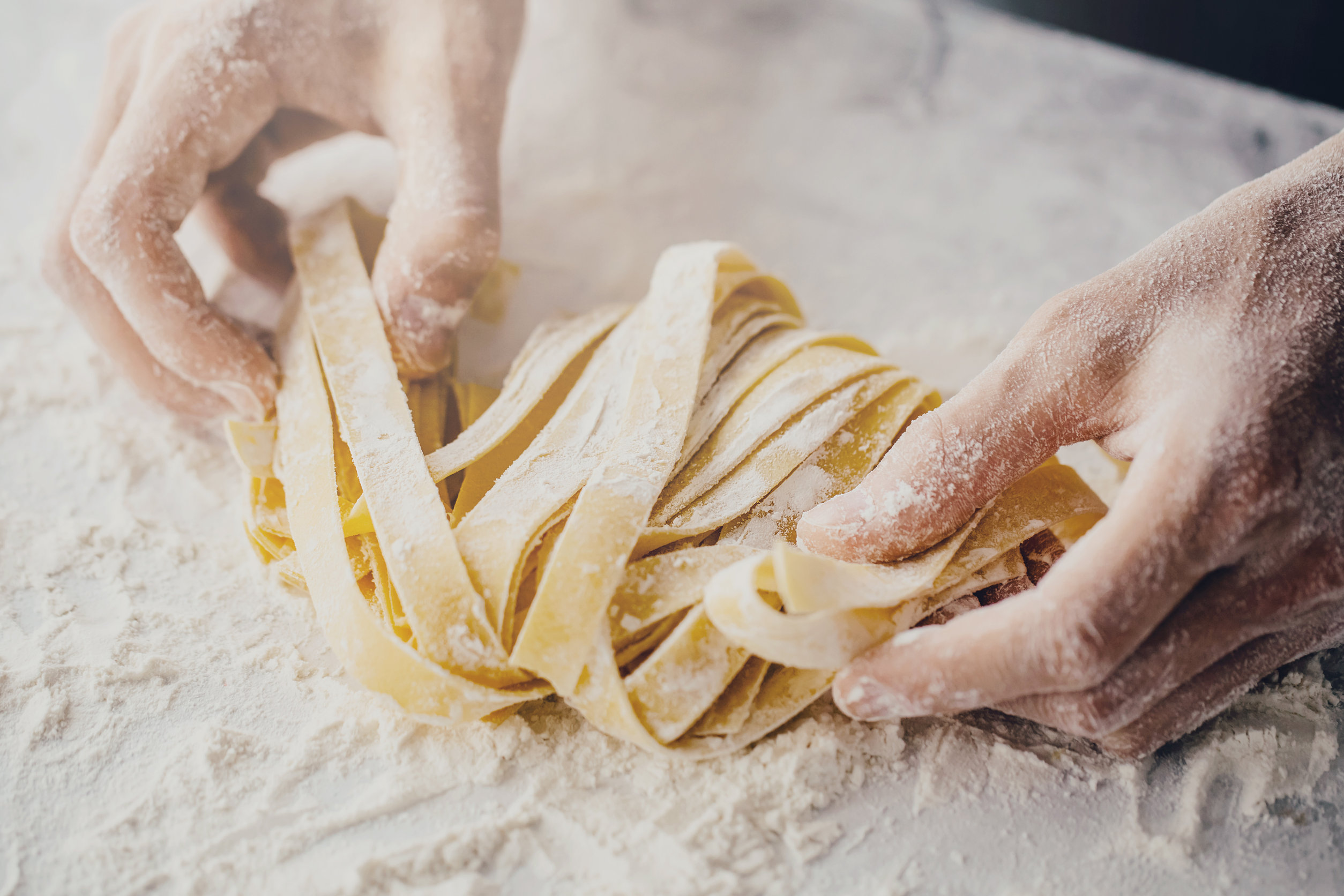 Closeup of process of making cooking homemade pasta. Chef make fresh italian traditional pasta